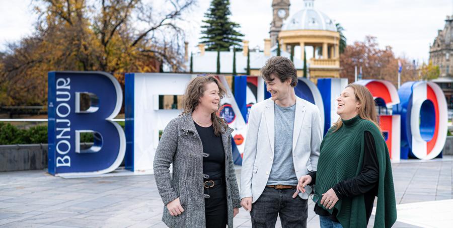 Ligantic co-founders in front of the Bendigo sign
